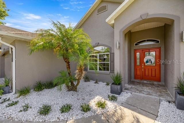 2418 SE 22nd Pl, Ocala, FL 34471 - view of exterior entry featuring stucco siding