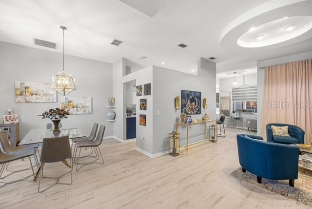 2418 SE 22nd Pl, Ocala, FL 34471 - dining area featuring light wood-style floors and a chandelier