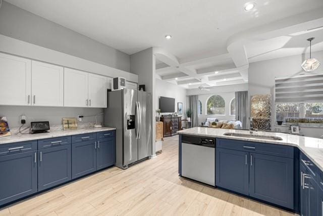 2418 SE 22nd Pl, Ocala, FL 34471 - kitchen featuring appliances with stainless steel finishes, blue cabinetry, coffered ceiling, open floor plan, and white cabinetry