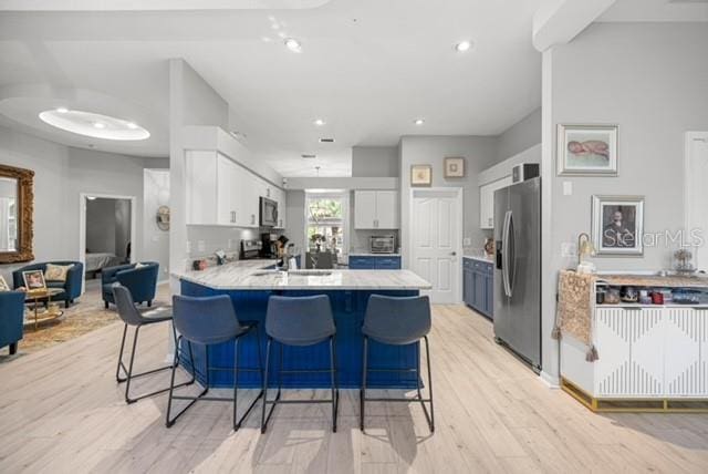 2418 SE 22nd Pl, Ocala, FL 34471 - kitchen featuring stainless steel appliances, a peninsula, light countertops, a breakfast bar, and recessed lighting