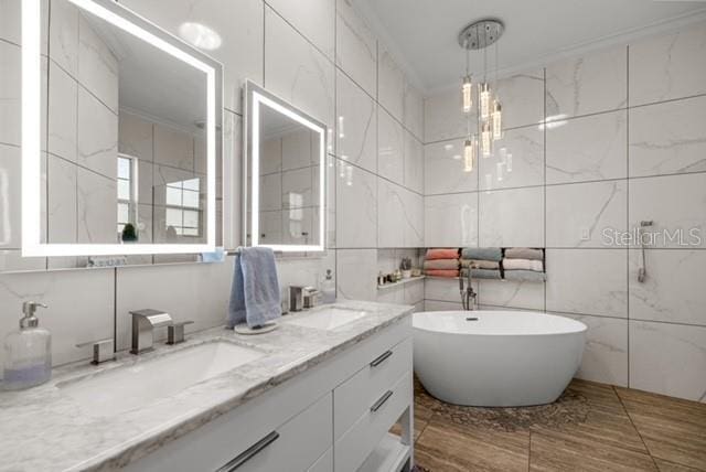 2418 SE 22nd Pl, Ocala, FL 34471 - full bathroom with tile walls, a freestanding tub, and double vanity