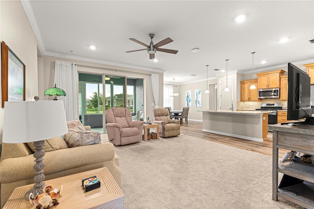 10597 SW 90th Street Rd, Ocala, FL 34481 - living area with crown molding, a ceiling fan, recessed lighting, light colored carpet, and light wood finished floors