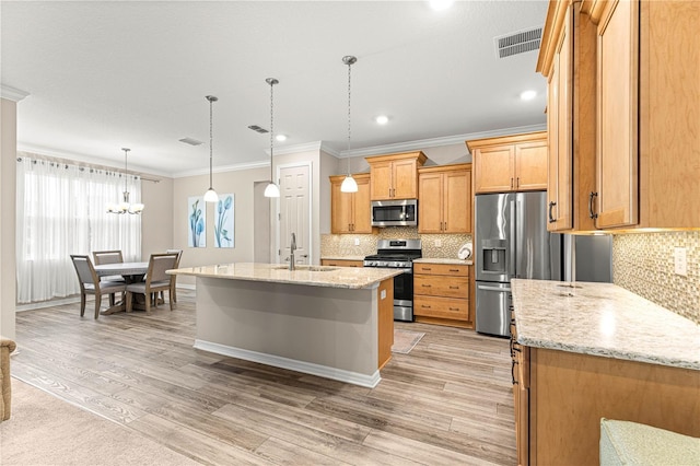 10597 SW 90th Street Rd, Ocala, FL 34481 - kitchen with stainless steel appliances, crown molding, light wood finished floors, tasteful backsplash, and hanging light fixtures