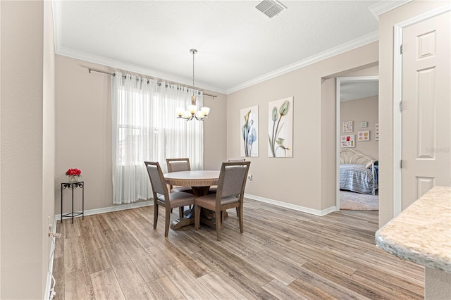 10597 SW 90th Street Rd, Ocala, FL 34481 - dining room with a chandelier, light wood-style floors, and crown molding