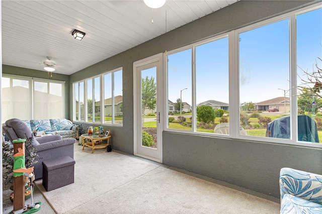 10597 SW 90th Street Rd, Ocala, FL 34481 - sunroom featuring carpet floors, ceiling fan, and a residential view