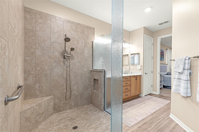 10597 SW 90th Street Rd, Ocala, FL 34481 - bathroom with walk in shower, vanity, wood finished floors, and connected bathroom