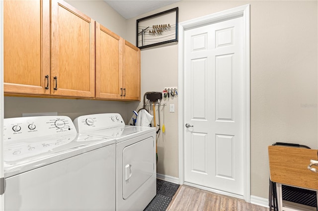 10597 SW 90th Street Rd, Ocala, FL 34481 - laundry room featuring washer and clothes dryer, cabinet space, and wood finished floors