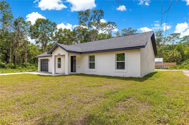 14876 SE 34th Ter, Summerfield, FL 34491 - view of front facade with stucco siding, a garage, a shingled roof, and a front yard