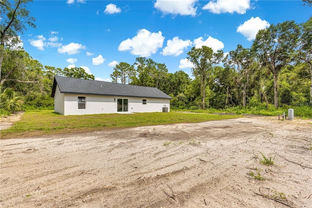 14876 SE 34th Ter, Summerfield, FL 34491 - rear view of property featuring a yard and stucco siding