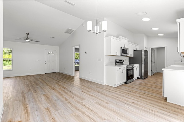 14876 SE 34th Ter, Summerfield, FL 34491 - kitchen featuring appliances with stainless steel finishes, open floor plan, light countertops, healthy amount of natural light, and high vaulted ceiling