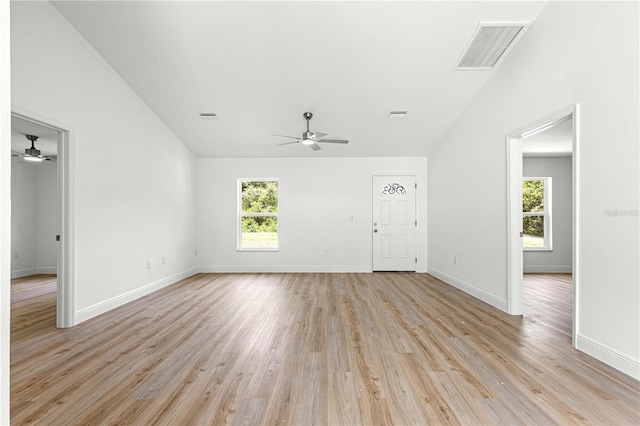 14876 SE 34th Ter, Summerfield, FL 34491 - unfurnished living room with ceiling fan, lofted ceiling, and light wood finished floors