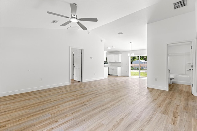 14876 SE 34th Ter, Summerfield, FL 34491 - unfurnished living room featuring vaulted ceiling, a ceiling fan, and light wood finished floors