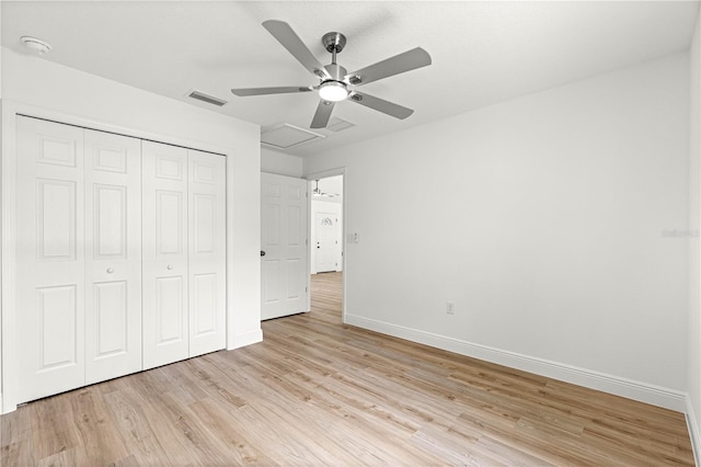 14876 SE 34th Ter, Summerfield, FL 34491 - unfurnished bedroom featuring light wood-style floors, a closet, and ceiling fan