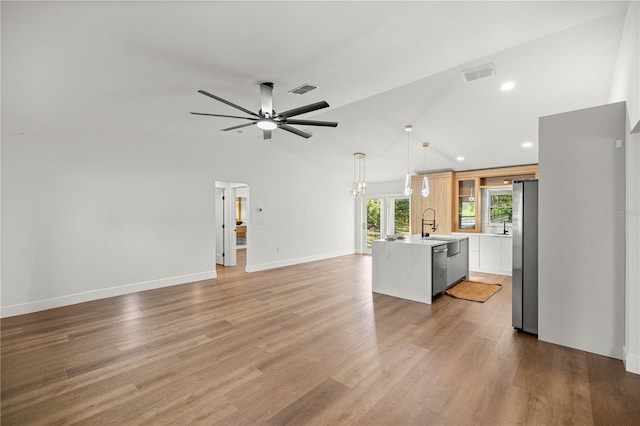 158 Guava Pass, Ocklawaha, FL 32179 - unfurnished living room featuring light wood-style flooring, ceiling fan, high vaulted ceiling, and recessed lighting