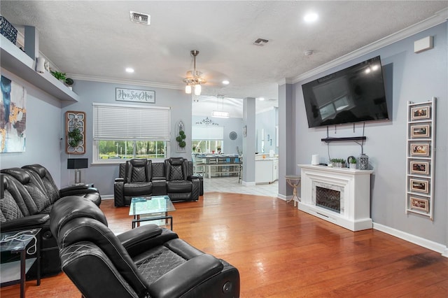 3549 SE 41st Pl, Ocala, FL 34480 - living area featuring ornamental molding, ceiling fan, wood finished floors, and recessed lighting