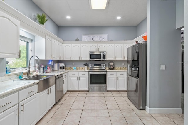 3549 SE 41st Pl, Ocala, FL 34480 - kitchen featuring appliances with stainless steel finishes, white cabinetry, light countertops, light tile patterned floors, and recessed lighting