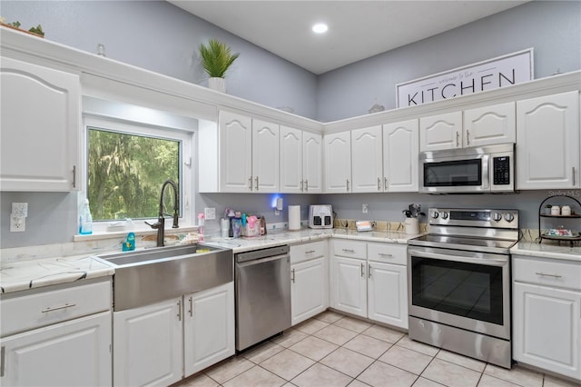 3549 SE 41st Pl, Ocala, FL 34480 - kitchen with stainless steel appliances, light countertops, white cabinetry, and light tile patterned floors