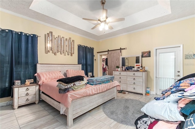 3549 SE 41st Pl, Ocala, FL 34480 - bedroom featuring a raised ceiling, ornamental molding, a textured ceiling, a barn door, and a ceiling fan