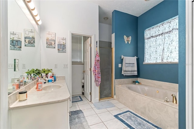3549 SE 41st Pl, Ocala, FL 34480 - full bathroom with vanity, a jetted tub, tile patterned flooring, a stall shower, and a textured ceiling