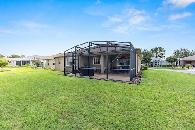 9222 SW 97th Cir, Ocala, FL 34481 - back of property featuring a patio, a lawn, and glass enclosure