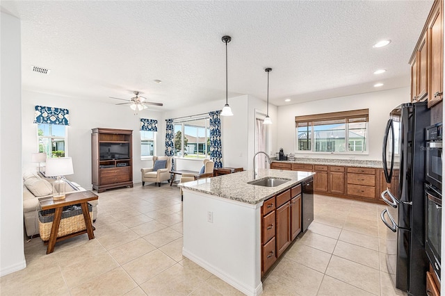 9222 SW 97th Cir, Ocala, FL 34481 - kitchen featuring brown cabinetry, black appliances, a textured ceiling, light tile patterned floors, and recessed lighting