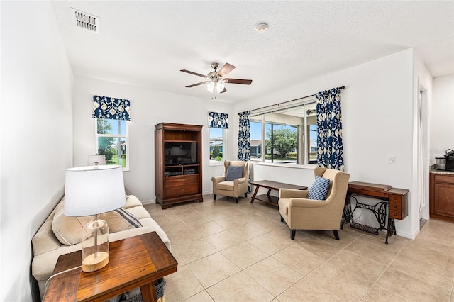 9222 SW 97th Cir, Ocala, FL 34481 - living room with plenty of natural light, light tile patterned flooring, a ceiling fan, and a textured ceiling