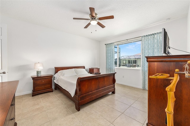 9222 SW 97th Cir, Ocala, FL 34481 - bedroom featuring light tile patterned flooring, a textured ceiling, and a ceiling fan