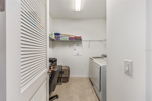 9222 SW 97th Cir, Ocala, FL 34481 - laundry area featuring separate washer and dryer, electric panel, and a textured ceiling