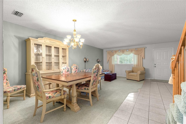 8830 SW 98th Pl Unit M, Ocala, FL 34481 - dining area with a chandelier, a textured ceiling, light colored carpet, and light tile patterned flooring