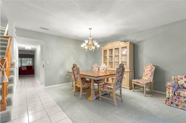 8830 SW 98th Pl Unit M, Ocala, FL 34481 - dining room featuring stairway, a textured ceiling, light carpet, light tile patterned flooring, and a chandelier