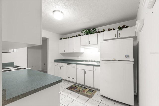 8830 SW 98th Pl Unit M, Ocala, FL 34481 - kitchen with fridge, dishwasher, a textured ceiling, white cabinetry, and dark countertops