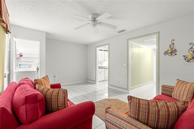 8830 SW 98th Pl Unit M, Ocala, FL 34481 - living room with light tile patterned flooring, a textured ceiling, a ceiling fan, and plenty of natural light