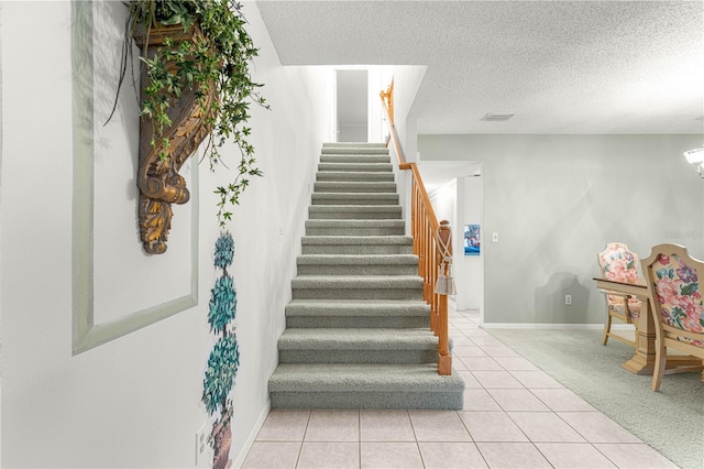 8830 SW 98th Pl Unit M, Ocala, FL 34481 - stairway featuring a textured ceiling, tile patterned flooring, and carpet flooring