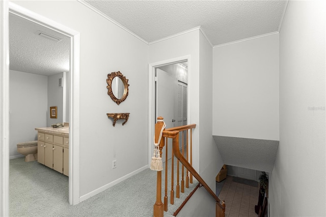 8830 SW 98th Pl Unit M, Ocala, FL 34481 - hall with an upstairs landing, a textured ceiling, crown molding, and light carpet