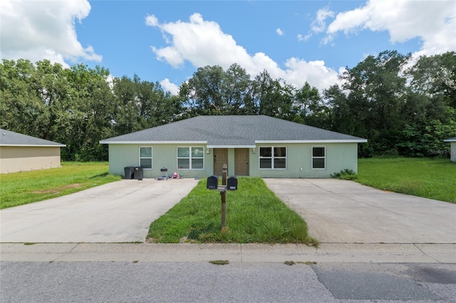 2139 NE 78th Ln, Ocala, FL 34479 - single story home with driveway, a front lawn, stucco siding, and roof with shingles