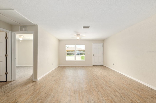 2139 NE 78th Ln, Ocala, FL 34479 - empty room featuring attic access, a ceiling fan, and light wood-style flooring