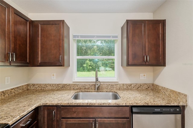 2139 NE 78th Ln, Ocala, FL 34479 - kitchen featuring stainless steel dishwasher, dark brown cabinetry, and light stone countertops