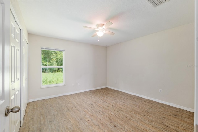 2139 NE 78th Ln, Ocala, FL 34479 - unfurnished bedroom featuring light wood finished floors and ceiling fan