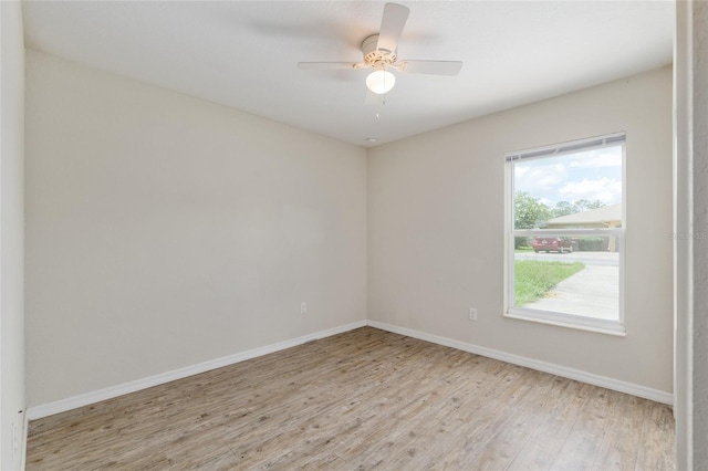 2139 NE 78th Ln, Ocala, FL 34479 - empty room with light wood finished floors and a ceiling fan