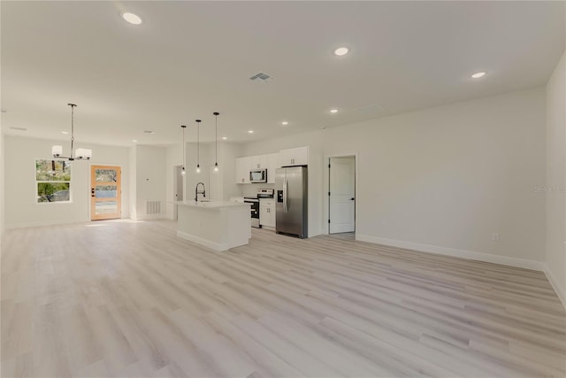3325 SW 165th Loop, Ocala, FL 34473 - unfurnished living room with a chandelier, recessed lighting, and light wood-type flooring