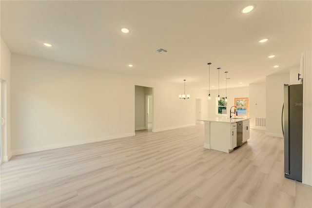 3325 SW 165th Loop, Ocala, FL 34473 - kitchen featuring appliances with stainless steel finishes, white cabinets, recessed lighting, open floor plan, and light wood-type flooring
