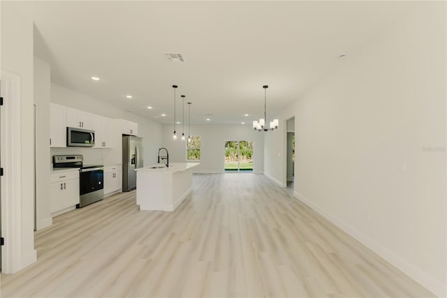 3325 SW 165th Loop, Ocala, FL 34473 - kitchen featuring appliances with stainless steel finishes, open floor plan, a chandelier, recessed lighting, and white cabinets