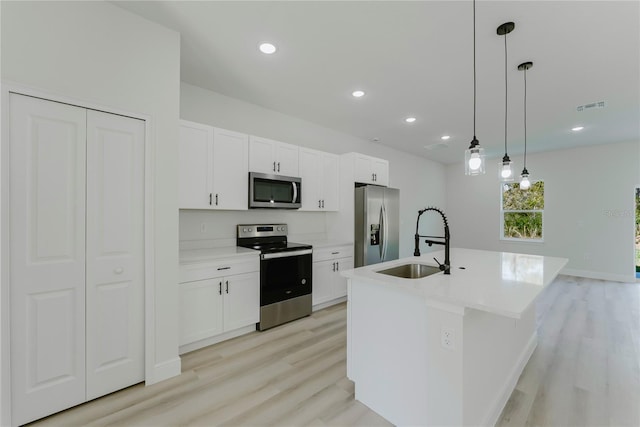 3325 SW 165th Loop, Ocala, FL 34473 - kitchen with appliances with stainless steel finishes, light wood finished floors, white cabinetry, and recessed lighting