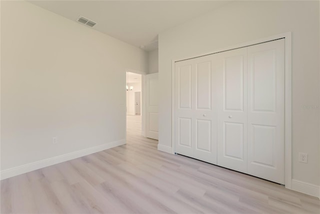 3325 SW 165th Loop, Ocala, FL 34473 - unfurnished bedroom with light wood-style floors and a closet