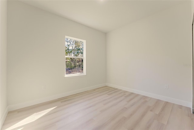 3325 SW 165th Loop, Ocala, FL 34473 - empty room with light wood-style floors and baseboards