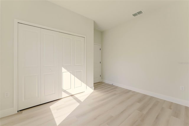 3325 SW 165th Loop, Ocala, FL 34473 - unfurnished bedroom featuring light wood-style floors and a closet