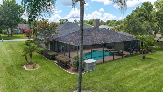 2908 SE 22nd Ave, Ocala, FL 34471 - rear view of property featuring an outdoor pool, a chimney, a lawn, a patio, and glass enclosure