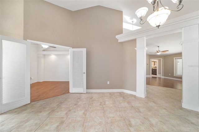 2908 SE 22nd Ave, Ocala, FL 34471 - spare room with ceiling fan, light tile patterned floors, decorative columns, a chandelier, and high vaulted ceiling