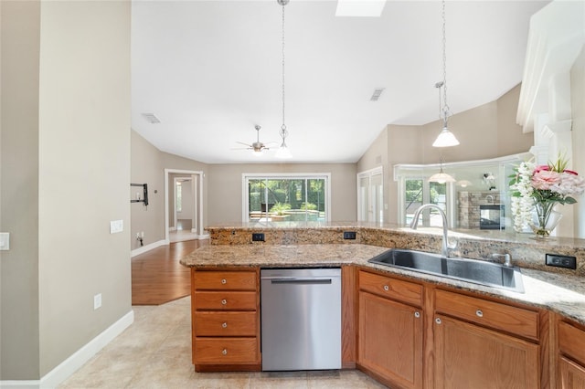 2908 SE 22nd Ave, Ocala, FL 34471 - kitchen with dishwasher, light stone counters, brown cabinetry, open floor plan, and hanging light fixtures