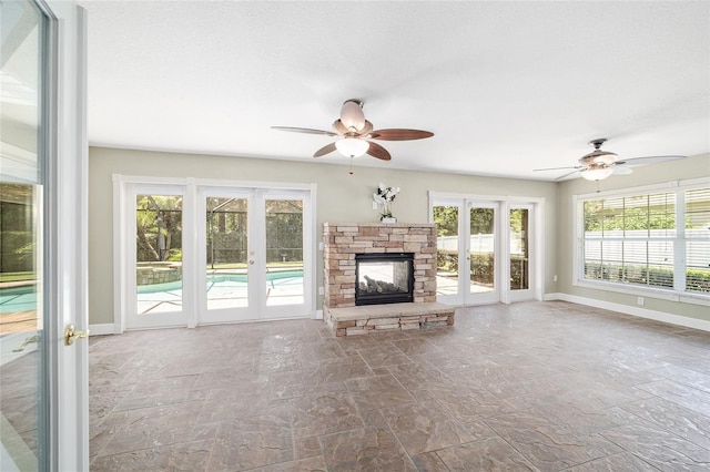 2908 SE 22nd Ave, Ocala, FL 34471 - unfurnished living room with a ceiling fan, stone finish floors, and a fireplace